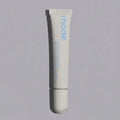 Tube of 'rhode' lip treatment on a gray background