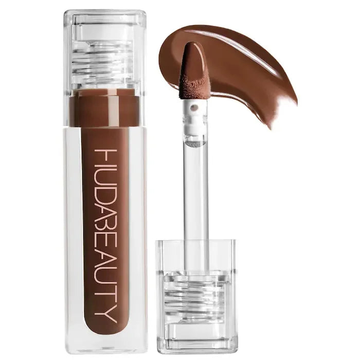 Huda Beauty lip product with applicator on a white background