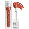 Lipstick with applicator and Huda Beauty branding on a white background