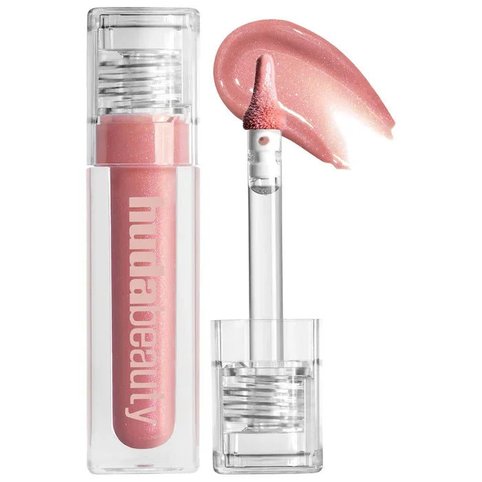 Pink lip gloss with applicator and swatch on a white background, featuring the brand 'Hudabeauty '.