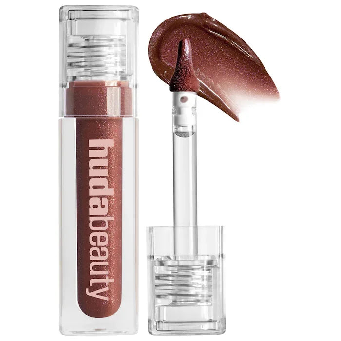 Huda Beauty lip gloss with applicator on a white background