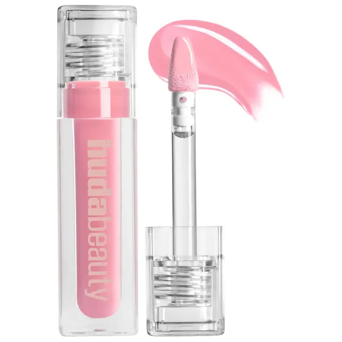 Pink lip gloss with clear cap on a white background, featuring the brand 'Hudabeauty '.