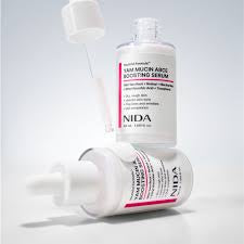 NIDA Micronizing Serum in a white bottle with pink and black text, shown with its applicator dropper and a second bottle on a light gray background.
