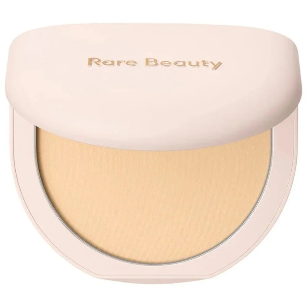 Compact powder with 'Rare Beauty' branding on a white background