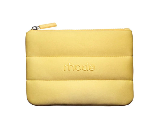 Yellow pouch with 'rhode' branding on a white background