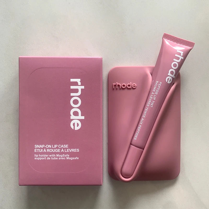 Pink lip case and tube with 'rhode' branding on a light gray background