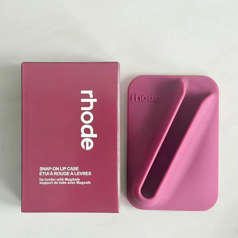 Raspberry lip case with 'rhode' branding next to its packaging on a light gray background