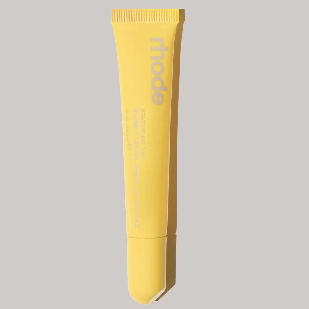 Yellow tube with 'rhode' branding on a gray background