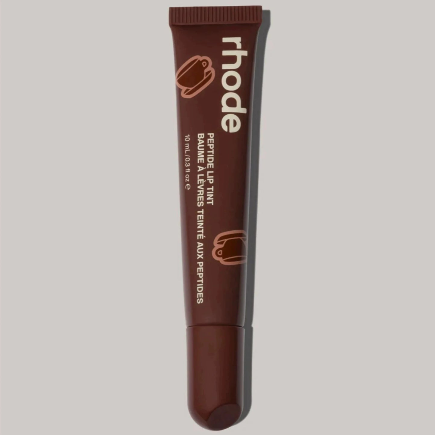 Brown lip tint tube with 'rhode' branding on a light gray background