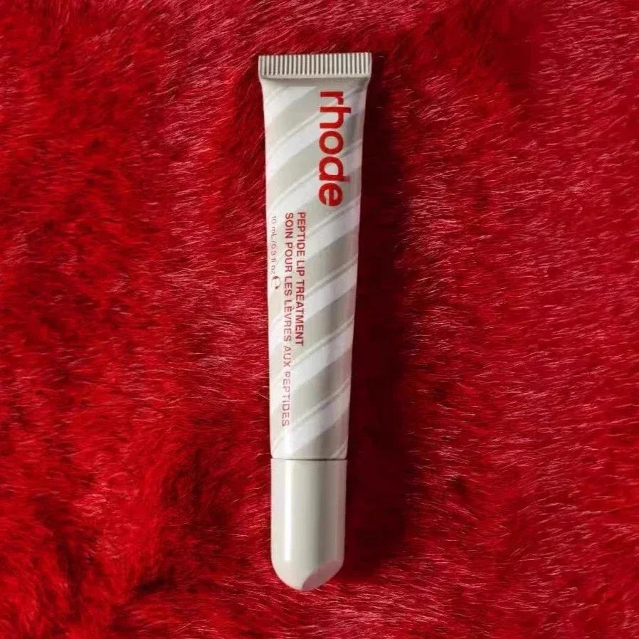 Tube of 'rhode' product on a red textured background