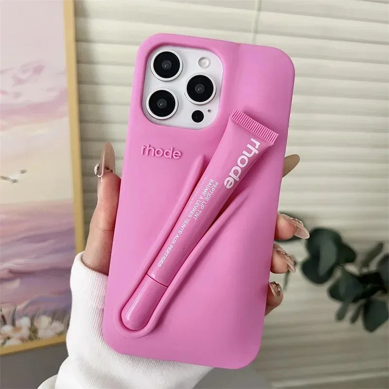 Pink phone case with a pen holder held by a hand, brand 'rhode' visible